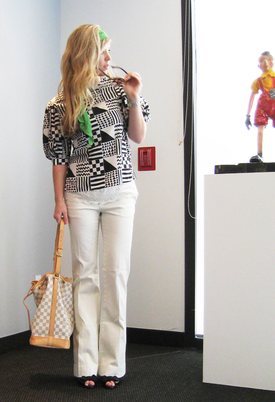 casual work style, white flair pants, vintage geometric print blouse, pouf sleeve blouse top, black and white and green outfit, spring outfits, louis vuitton noe bag light damier