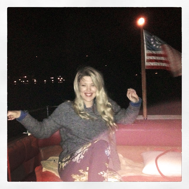 maegan on a boat with an american flag in lake arrowhead