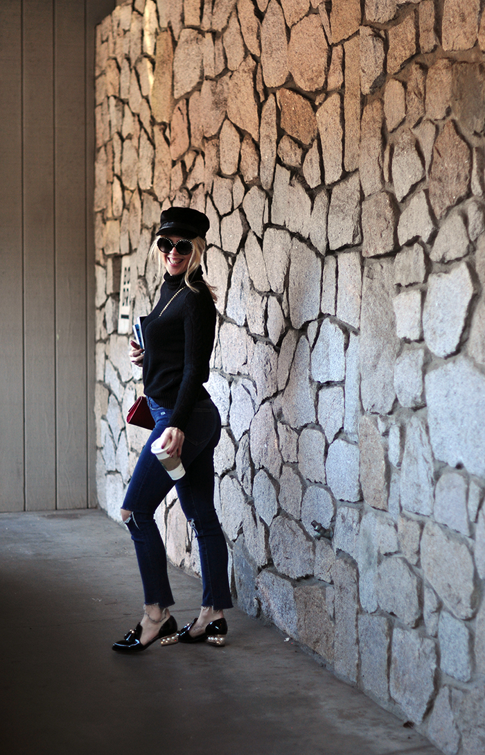 retro casual 60s style, big round embellished sunglasses, jeans and a turtleneck, red cross body bag, loafers, casual street style