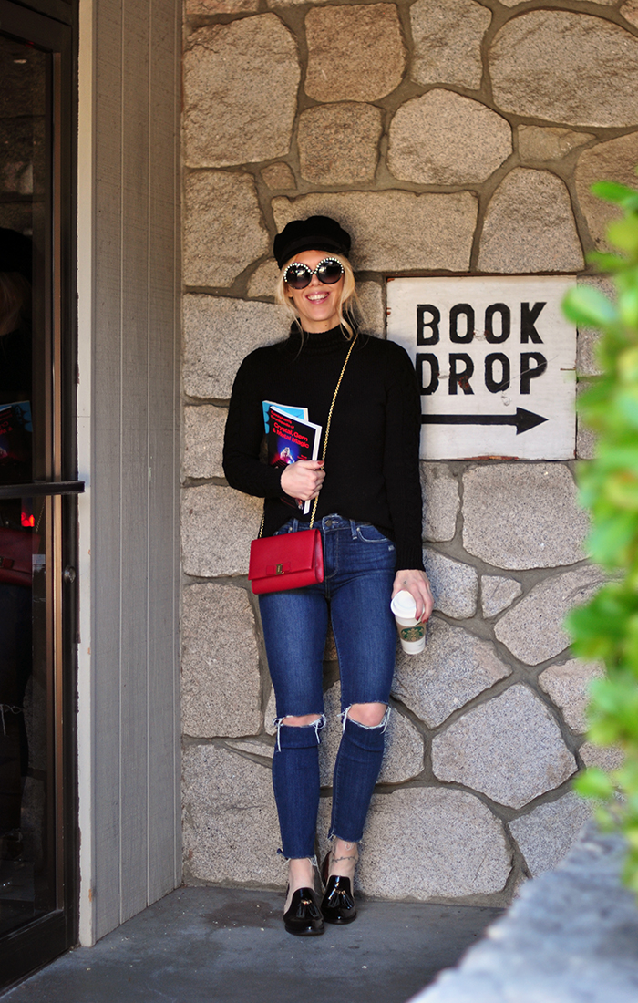 retro casual 60s style, big round embellished sunglasses, jeans and a turtleneck, red cross body bag, loafers, casual street style