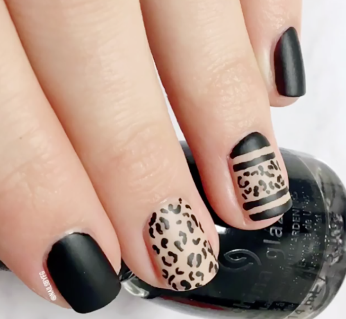 classic matte black manicure with leopard print accent nails