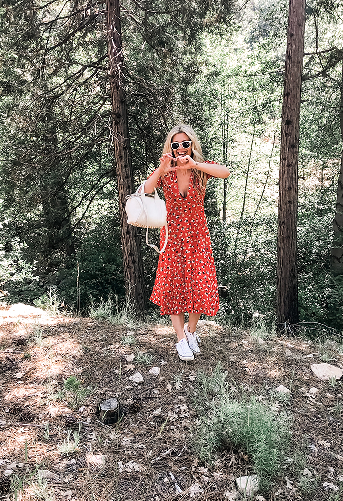 red floral dress with sneakers in the forest