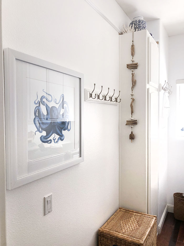 light and airy clean white laundry room with nautical beach decor