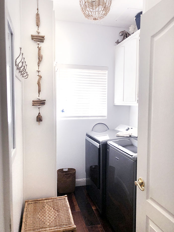clean and simple white laundry room with nautical beachy decor
