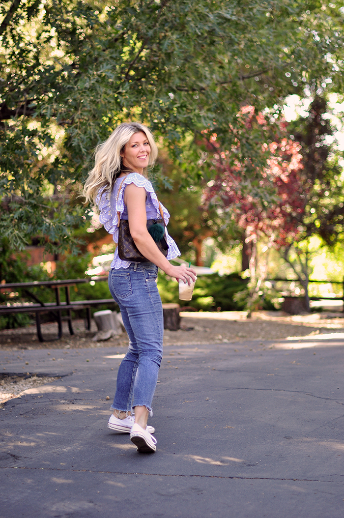 cute summer outfit - jeans and a cute ruffled top with converse sneakers