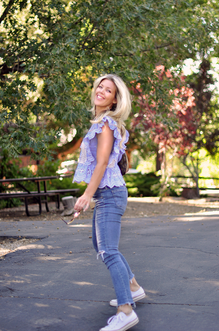 cute summer outfit - jeans and a cute ruffled top with converse sneakers