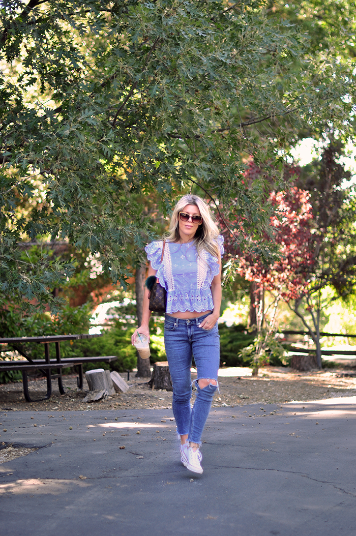 cute summer outfit - jeans and a cute ruffled top with converse sneakers