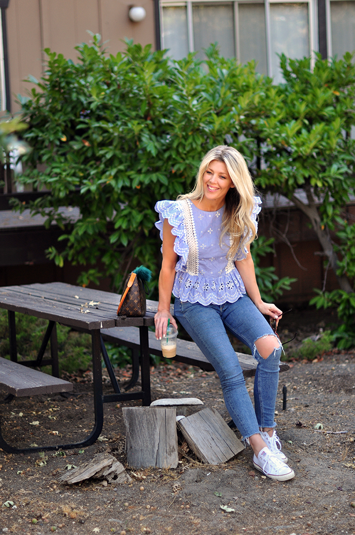 cute summer outfit - jeans and a cute ruffled top with converse sneakers