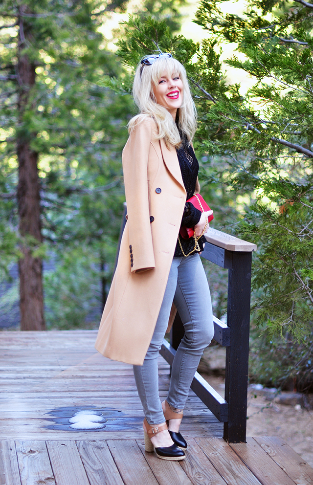 grey jeans lace peplum top and camel coat with red lips and bangs