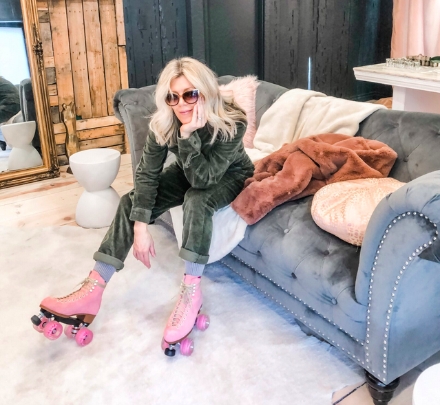 sitting on a couch, grey tufted sofa, corduroy coveralls jumpsuit, pink roller skates, love maegan's office