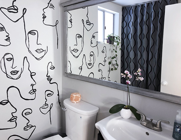 before and after small bathroom makeover with hand painted wall line art faces on the wall, wall paper alternative, drawing on walls, wall mural, accent walls, budget bathroom makeover