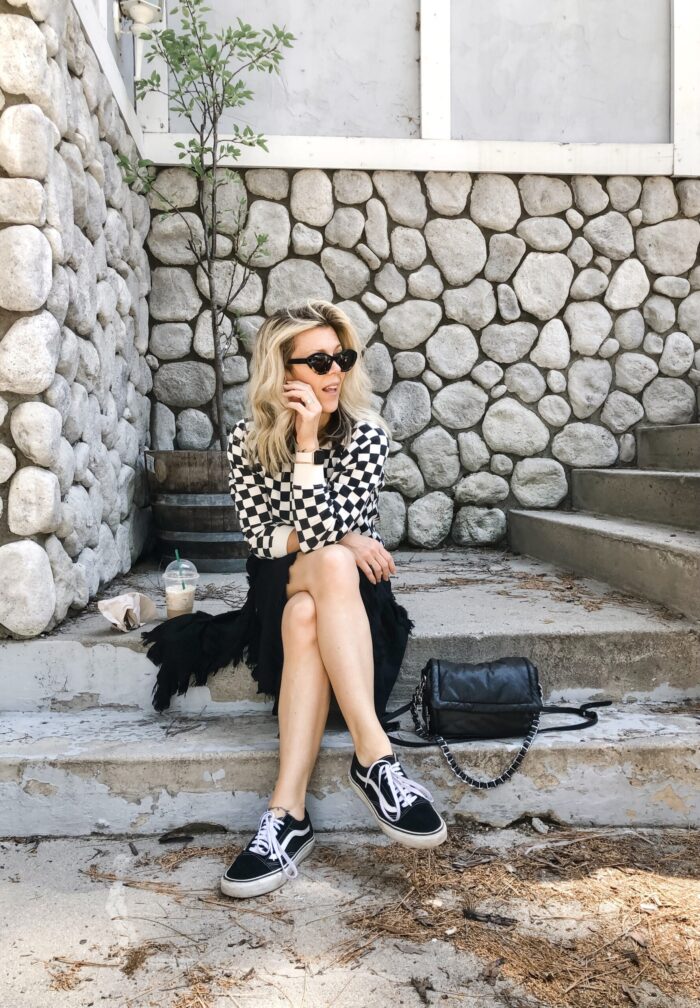 checkered sweatshirt with a dress and sneakers