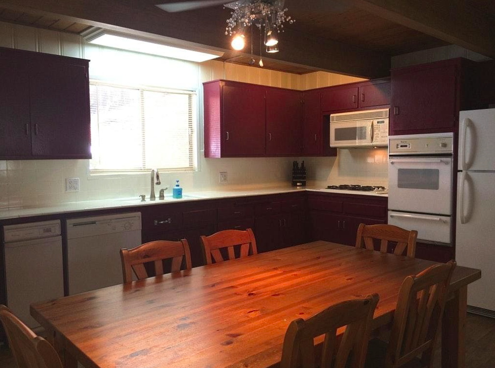 old small kitchen before with burgundy cabinets