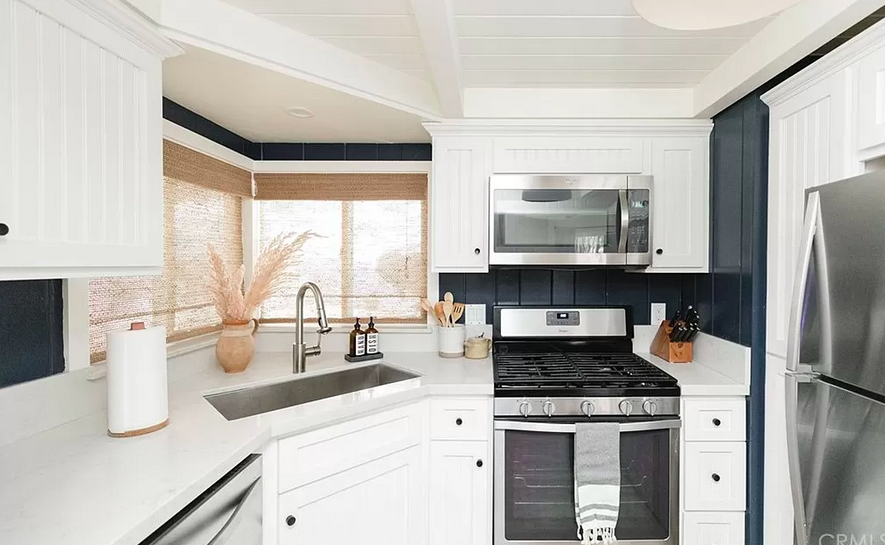 all white kitchen with dark paneled backsplash walls, contemporary mountain house in lake arrowhead