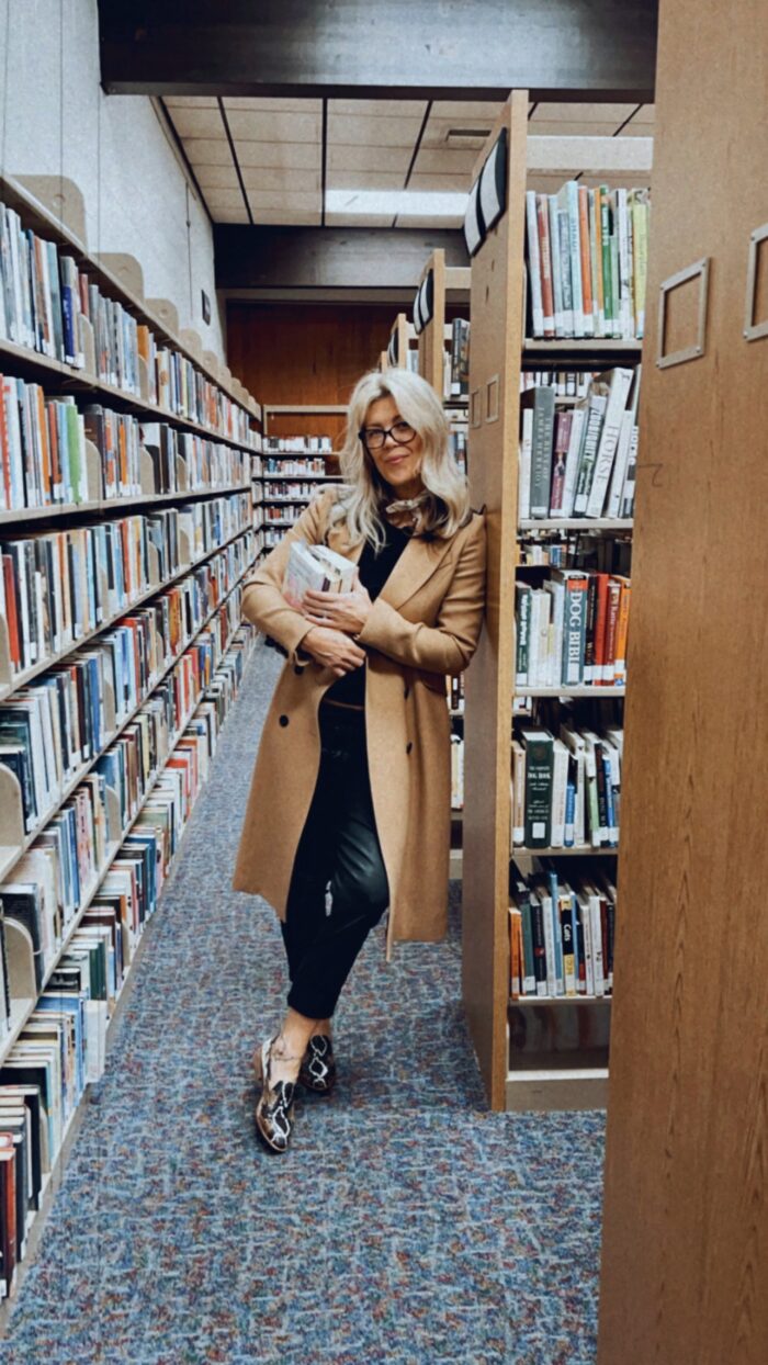 in the library, library books, books, library aesthetic, camel coat, snakeskin loafers, black outfit, faux leather pants, library style, fall style, lake arrowhead library, blonde with glasses, in the library
