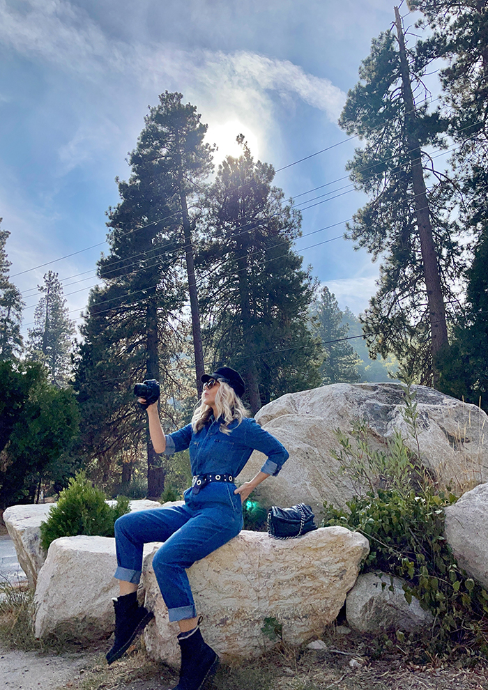 lee denim coveralls, denim jumpsuit, woman sitting on large rocks, blue skies, tall trees, lake arrowhead, bloggers in LA