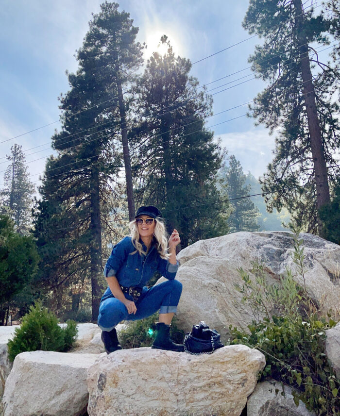 lee denim coveralls, denim jumpsuit, woman sitting on large rocks, blue skies, tall trees, lake arrowhead, bloggers in LA