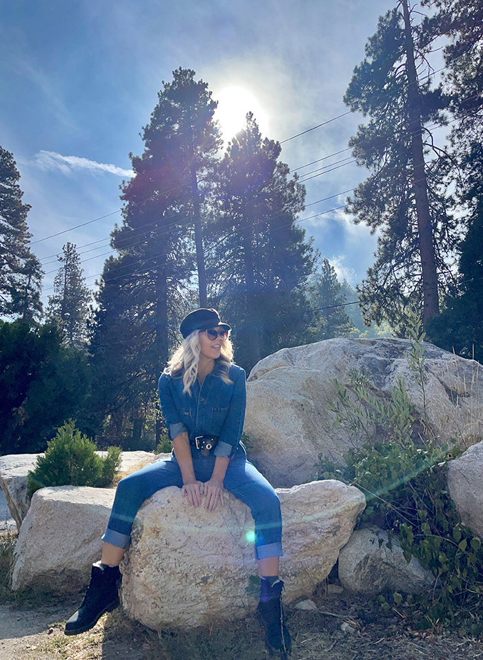 lee denim coveralls, denim jumpsuit, woman sitting on large rocks, blue skies, tall trees, lake arrowhead, bloggers in LA