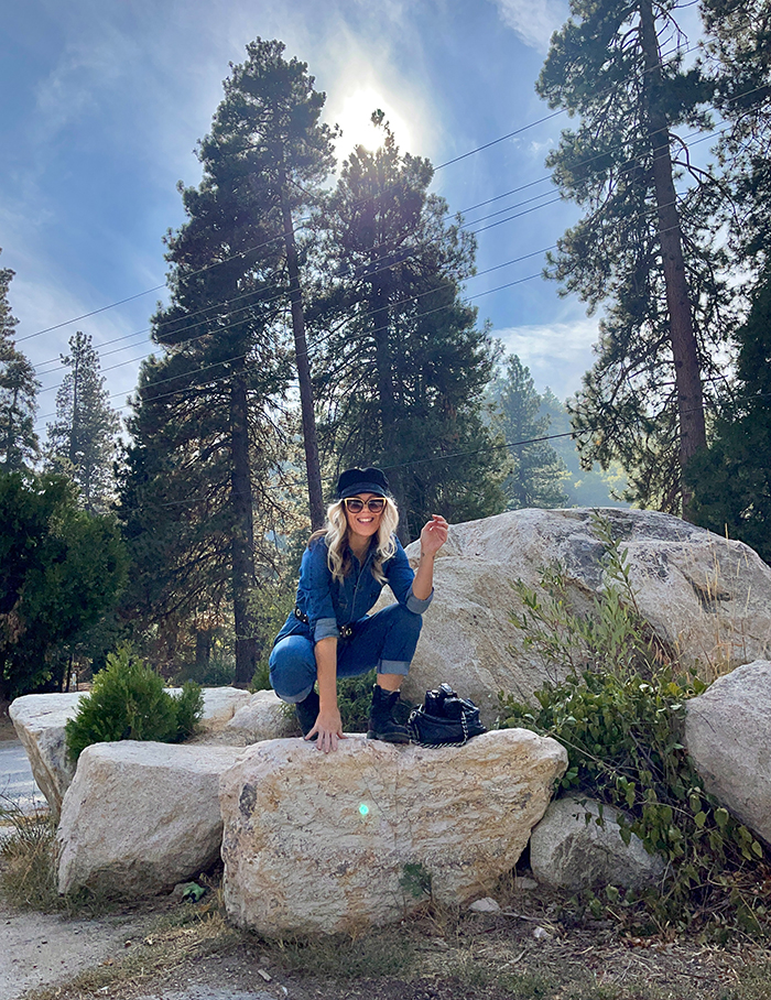 lee denim coveralls, denim jumpsuit, woman sitting on large rocks, blue skies, tall trees, lake arrowhead, bloggers in LA