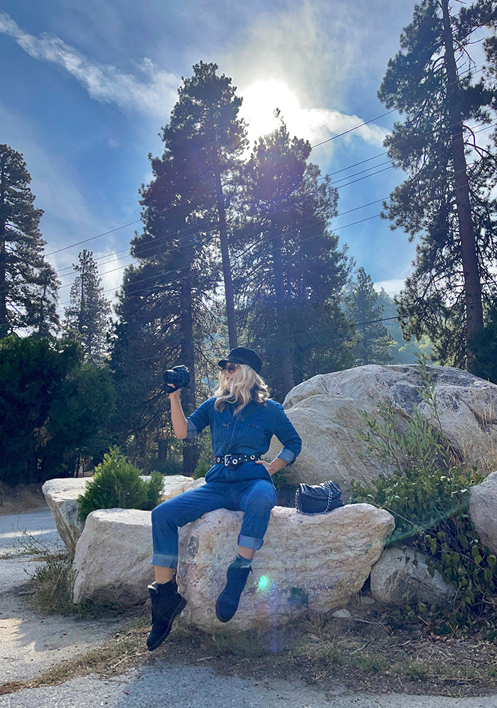 lee denim coveralls, denim jumpsuit, woman sitting on large rocks, blue skies, tall trees, lake arrowhead, bloggers in LA