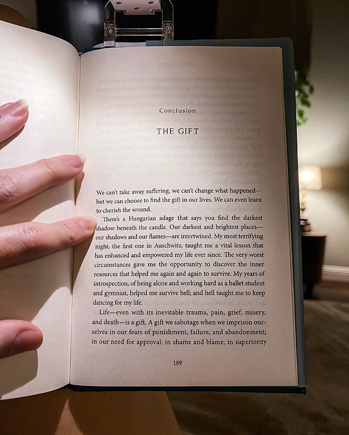 holding a book open to a page-the gift