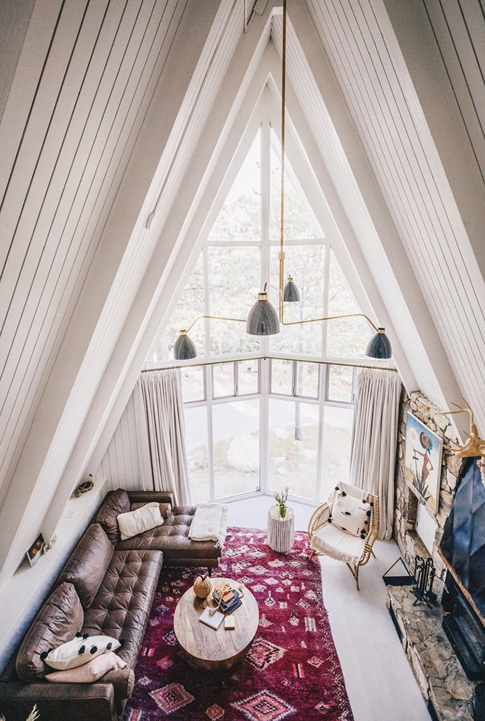 a-frame cabin with a pink door, white mountain cabin with pink door