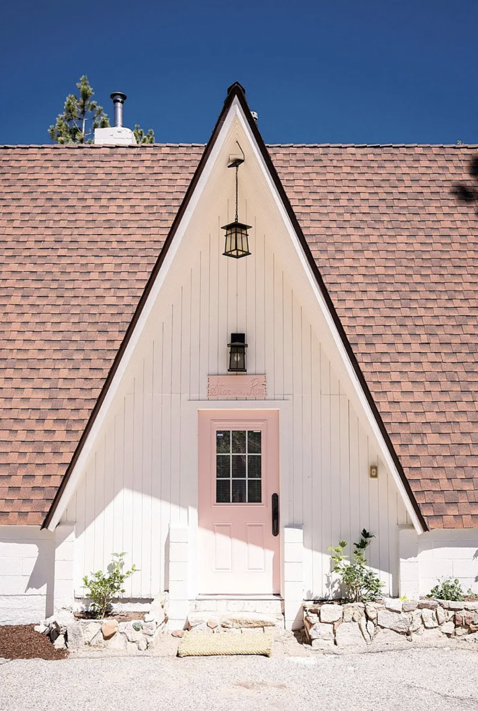 Little mountain a-frame, white a-frame cabin with pink door