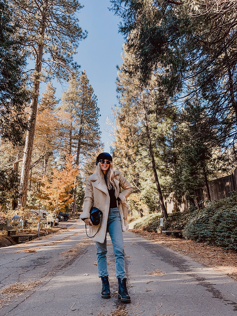 fall style, casual style with jeans, blonde on a tree lined street in the fall in lake arrowhead, love maegan