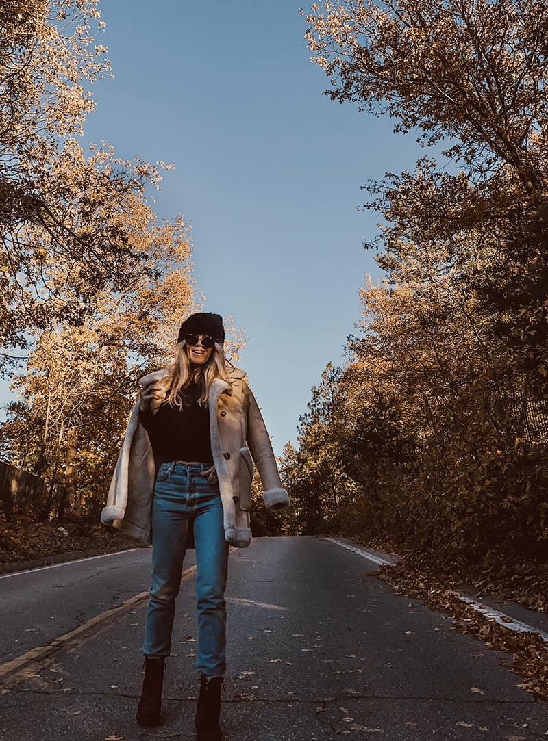 fall style, casual style with jeans, blonde on a tree lined street in the fall in lake arrowhead, love maegan