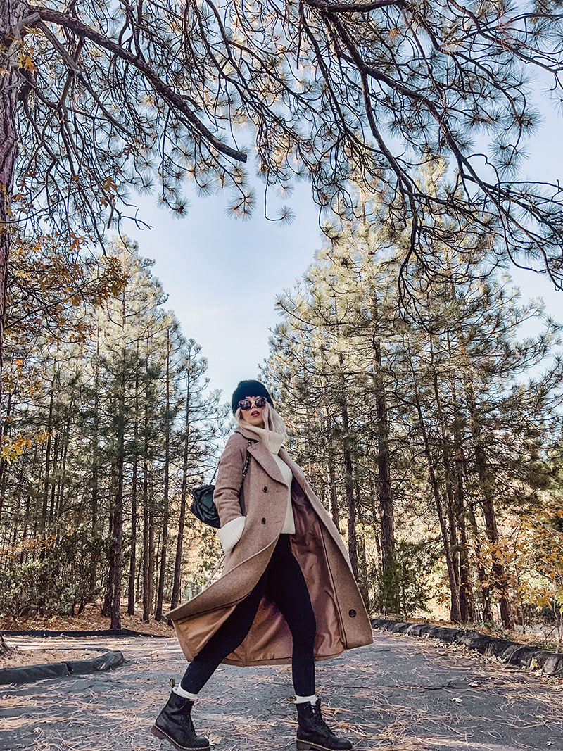 casual chic fall style in dressed up leggings look with long wool coat in neutral colors on a tree lined street in fall