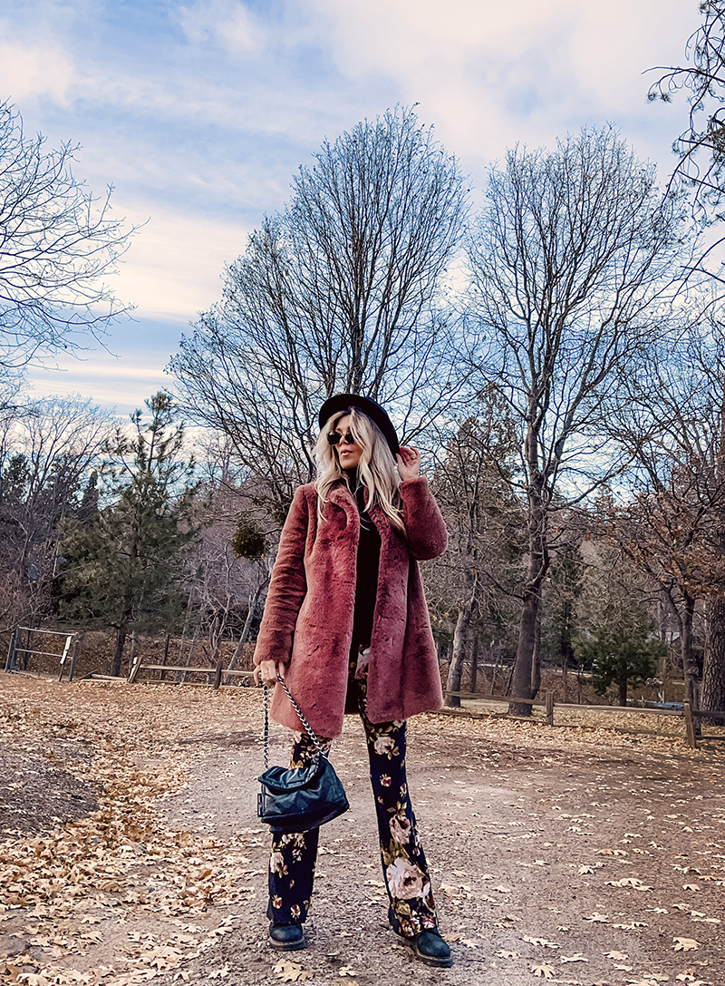 70s boho style, flared bell bottom floral pants with a black turtleneck, faux fur coat and doc martens