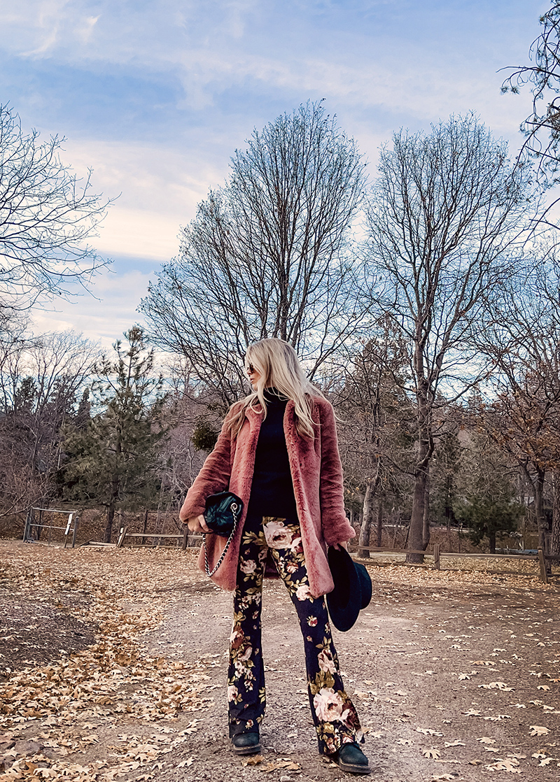 70s boho style, flared bell bottom floral pants with a black turtleneck, faux fur coat and doc martens