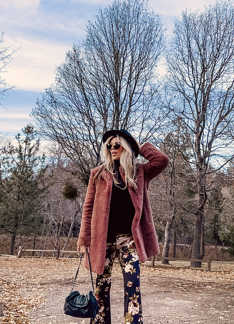 70s boho style, flared bell bottom floral pants with a black turtleneck, faux fur coat and doc martens