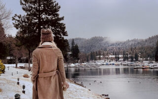 walking along the lake in the snow-lake arrowhead-long brown coat-ducks in the water-snow