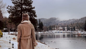 walking along the lake in the snow-lake arrowhead-long brown coat-ducks in the water-snow