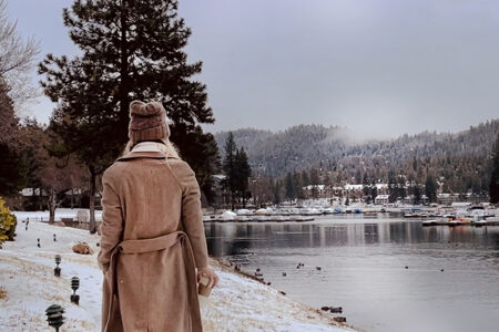 walking along the lake in the snow-lake arrowhead-long brown coat-ducks in the water-snow