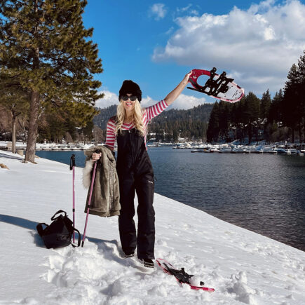 Black-and-pink-outfit-in-the-snow-with-snowshoes-on-the-lake arrowhead