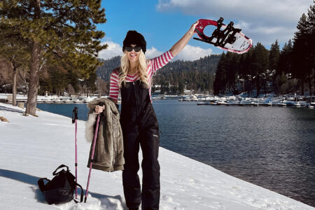 Black-and-pink-outfit-in-the-snow-with-snowshoes-on-the-lake arrowhead