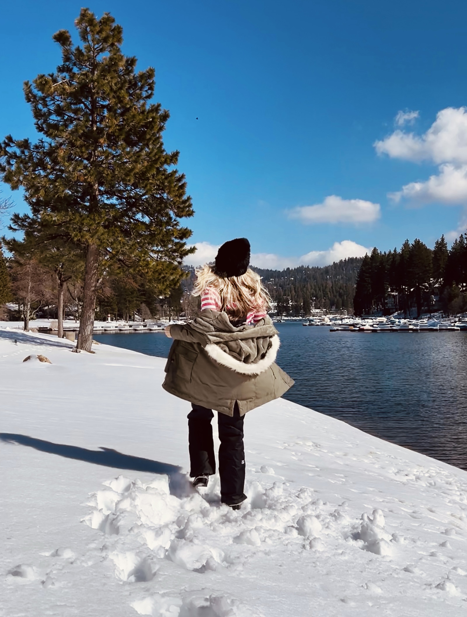 pink and black retro outfit in the snow, pink snowshoes, snowshoes, snow shoes, lake arrowhead, black waterproof snow overalls bib, vintage pink and white striped 3/4