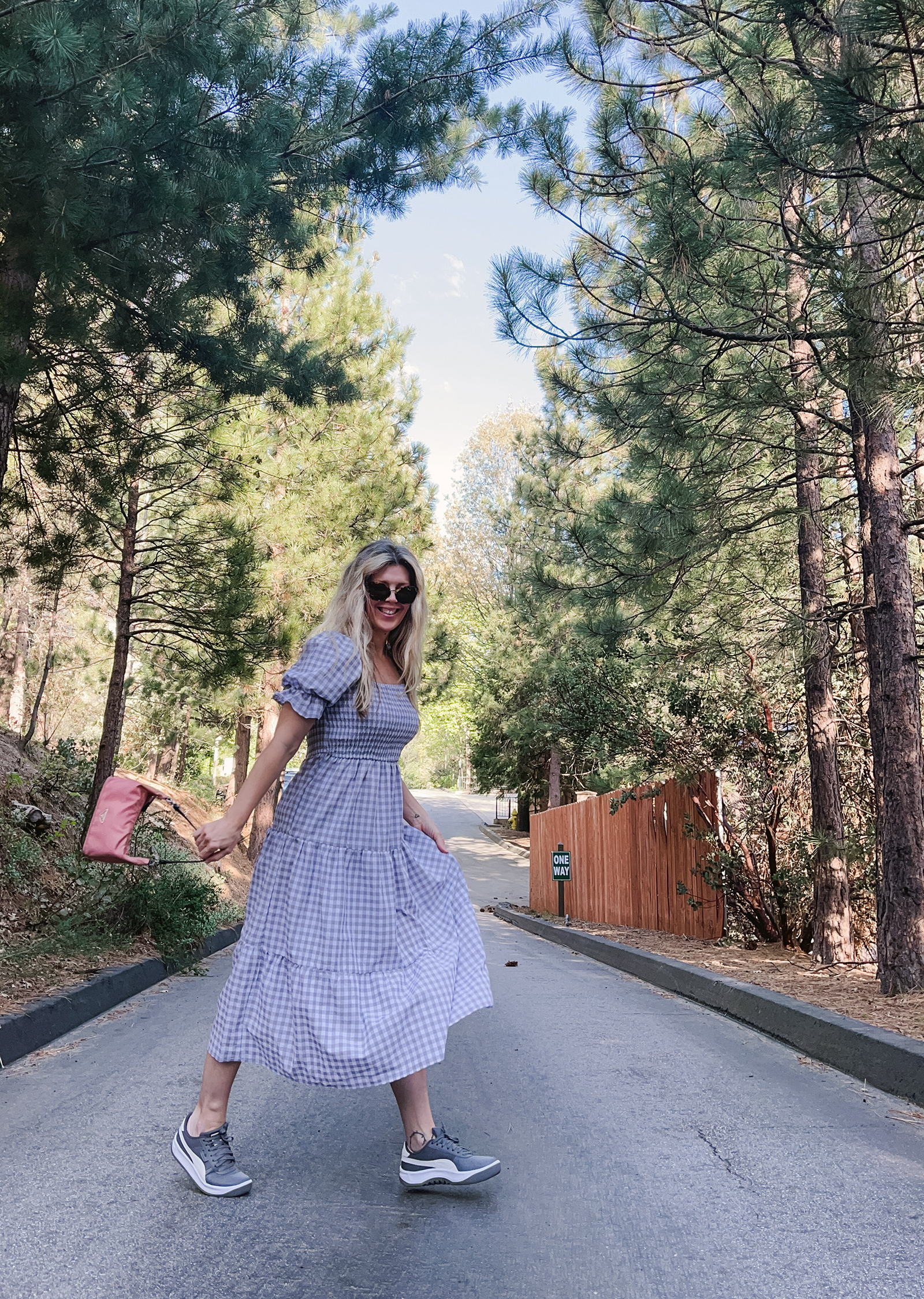 grey and white midi gingham dress with puff sleeves and tiers with vintage pink prada nylon bag and gray puma california casual sneakers in lake arrowhea