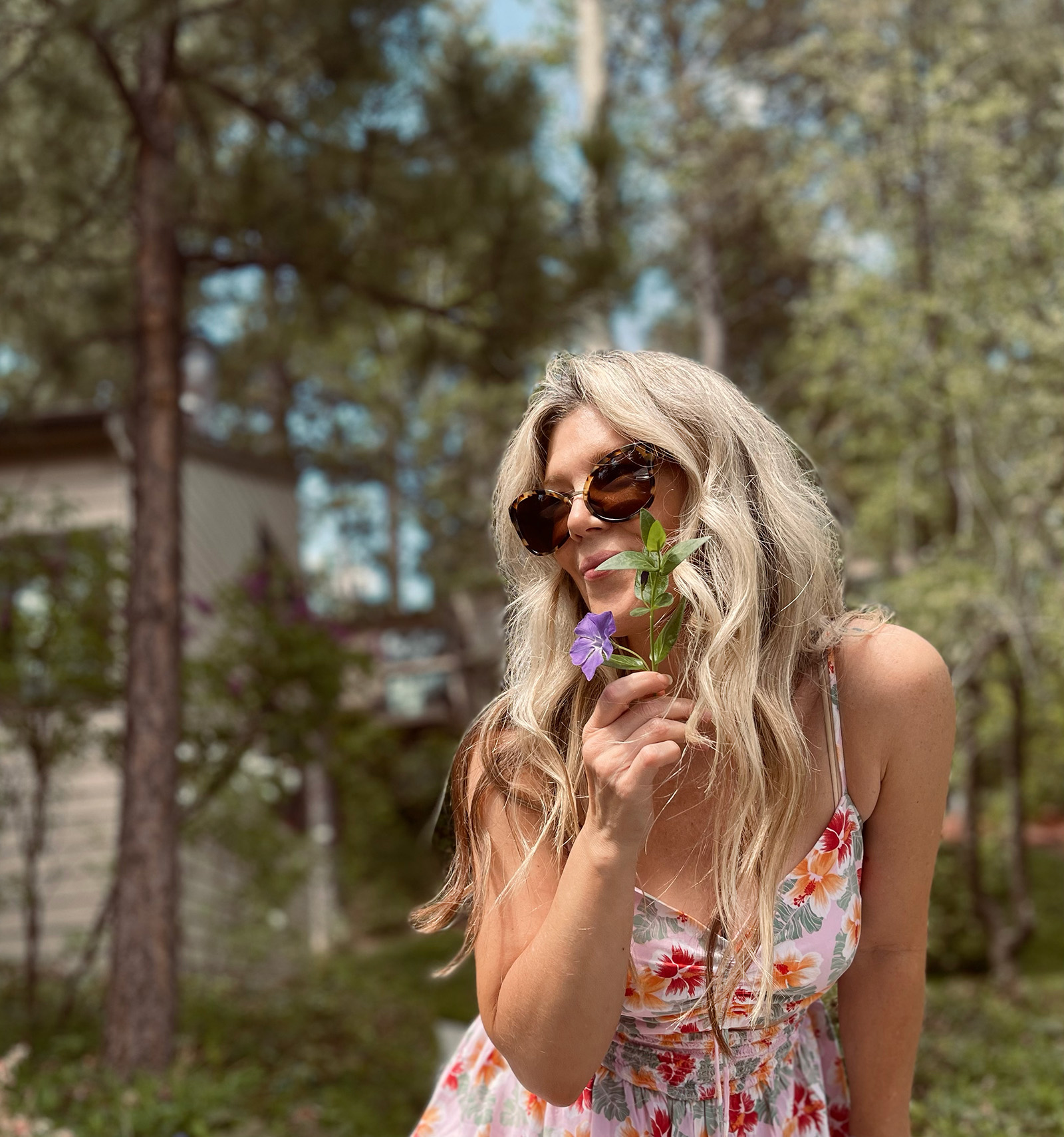 pink tropical print cut out romper for spring and summer cute and feminine with white crocs and vintage nylon prada bag with long dirty blonde beach waves hair style