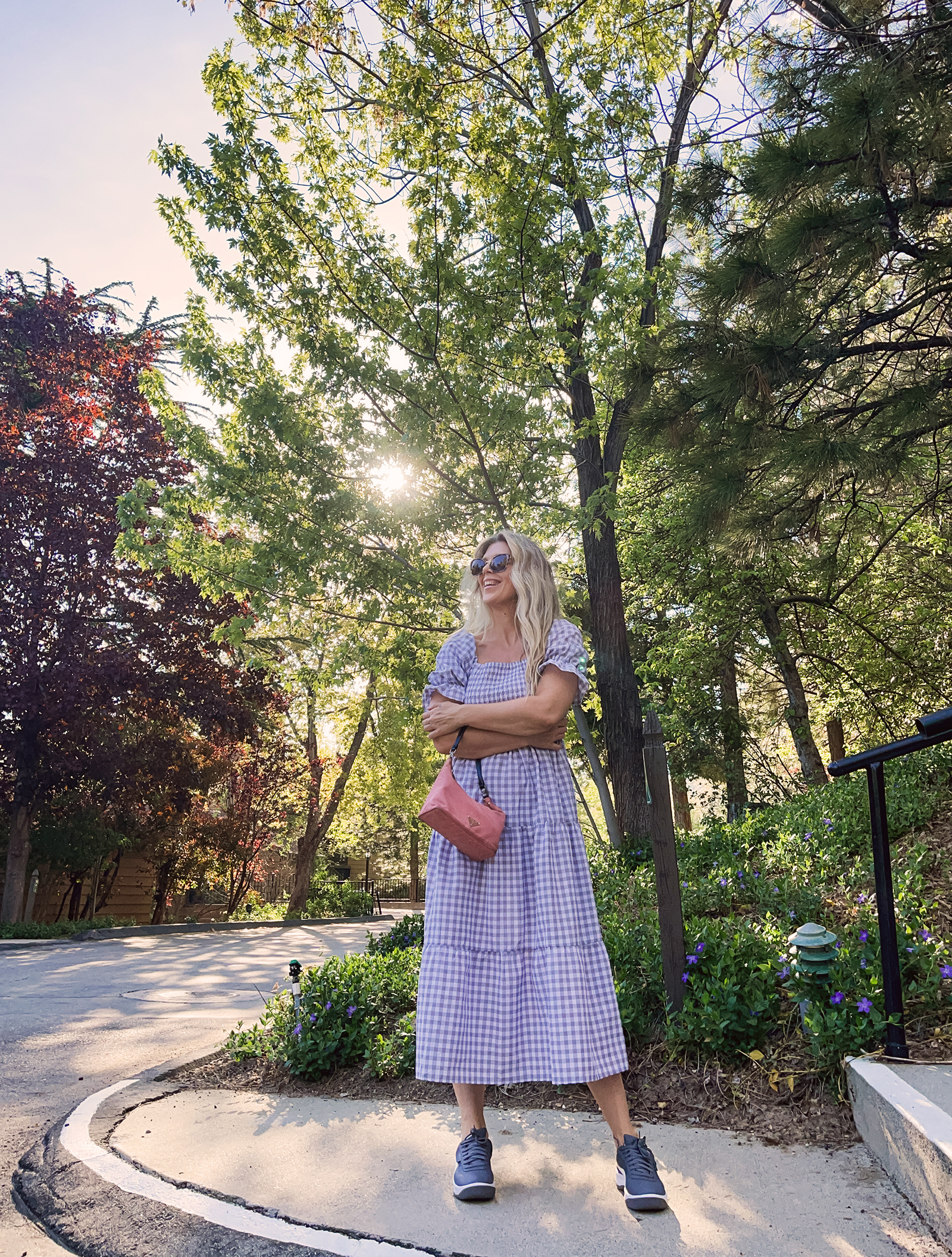 grey and white midi gingham dress with puff sleeves and tiers with vintage pink prada nylon bag and gray puma california casual sneakers in lake arrowhea