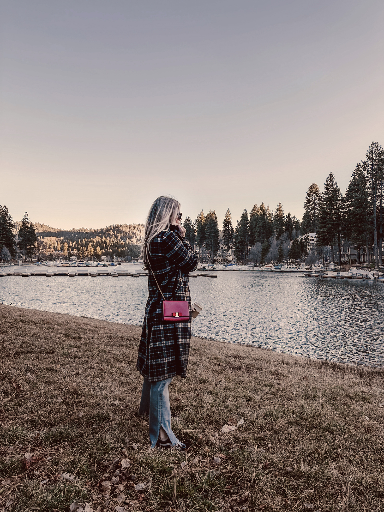 late winter outfit by the lake in vintage levi's jeans with split hems and a long plaid coat with old skool vans and a red bag giving 90s style in 90s clothes I've had since the 90s