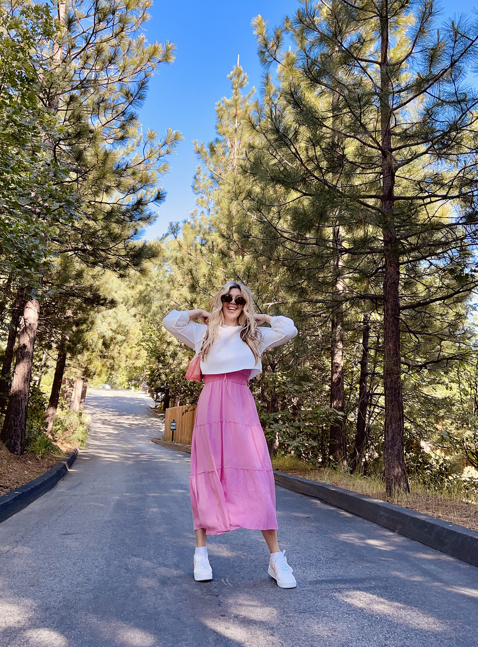 pink tiered maxi dress with white cropped sweatshirt and nike air force