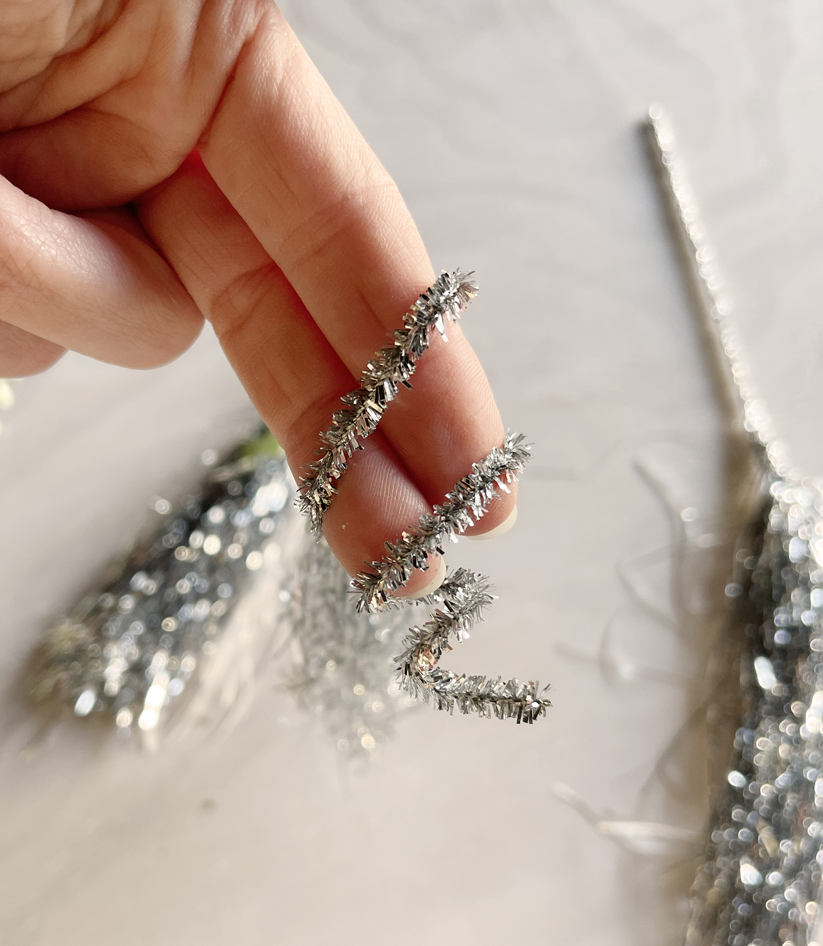 how to recycle and reuse your christmas tree tinsel into tassels for ornaments or gift wrapping or party decor