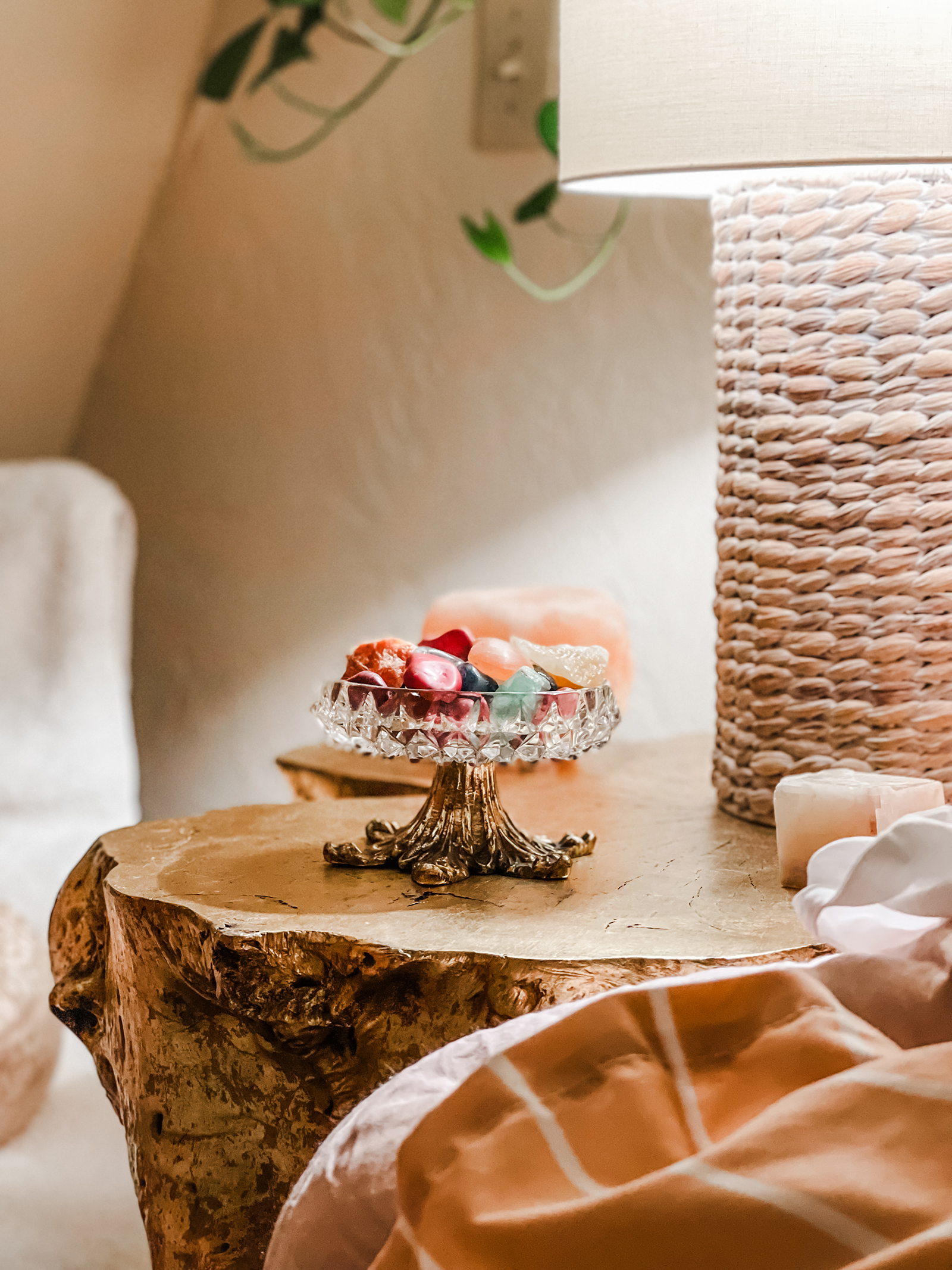 colorful healing crystals and stones in a crystal glass bowl with gold leaf feet, vintage crystal pedestal candy dish