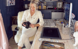 ivory unionalls sitting at desk in office