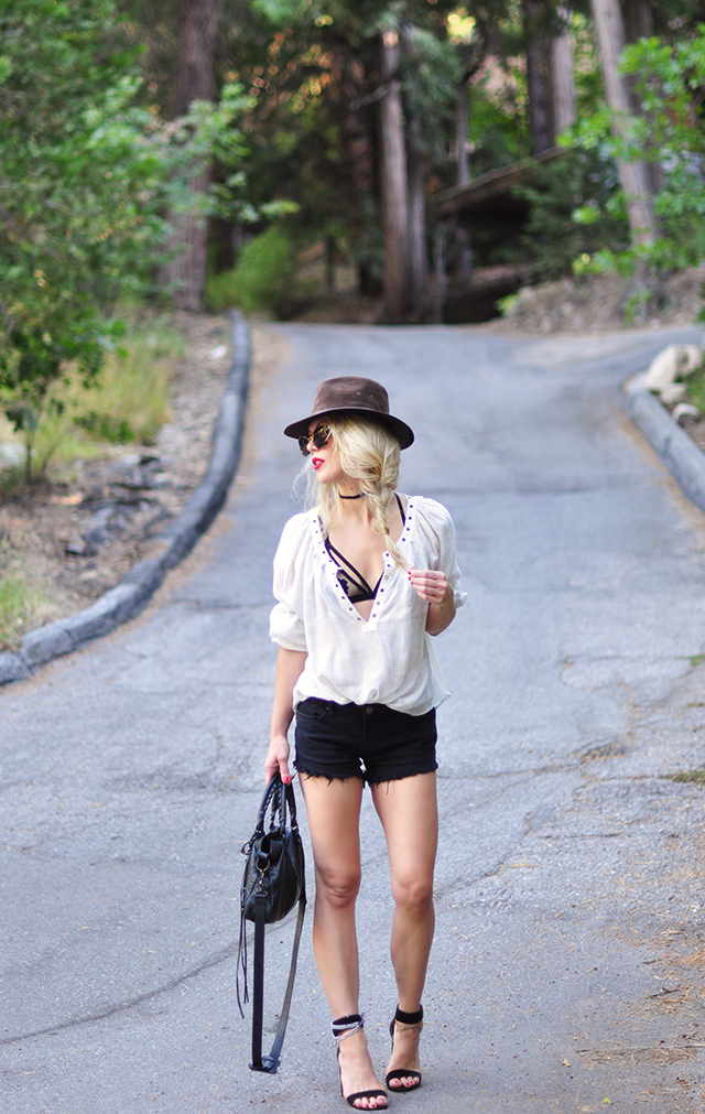 Boho style_black cutoffs_top with bra showing_hat_balenciaga bag