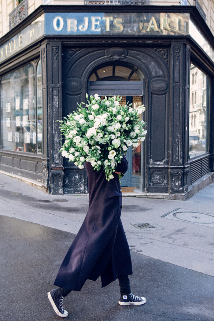 girls carrying flowers over their face