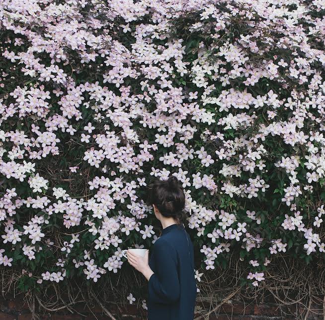 Girl with coffee and flowers